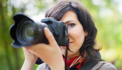 beautiful female photographer with camera outdoor